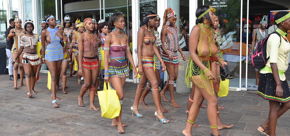 Essence Festival in Durban,. Zulu women walking, some with bare breasts